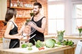 Sports couple eating healthy food on the kitchen at home