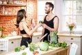 Sports couple eating healthy food on the kitchen at home