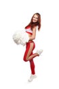 Young sports flexible cheerleader girl in red sweatpants and red top holding pom-poms. Royalty Free Stock Photo