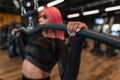 Young sports girl doing exercise on training apparatus machine in the gym, close up Royalty Free Stock Photo