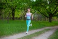 A young sports girl running in a quit green summer forest. Sport and wellness Royalty Free Stock Photo