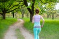 A young sports girl running in a quit green summer forest. Sport and wellness Royalty Free Stock Photo