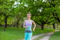 A young sports girl running in a quit green summer forest. Sport and wellness Royalty Free Stock Photo