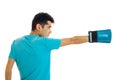 Young sports man in blue shirt practicing boxing in gloves isolated on white background Royalty Free Stock Photo