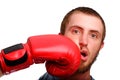 A young sports man-boxer poses to the camera. Man got a punch to the face by red boxing glove Royalty Free Stock Photo