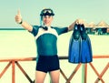 Young sports man with flippers, mask and tube near the ocean