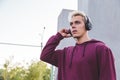 Young sports man in hoodie with headphones on work out area Royalty Free Stock Photo