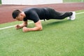 A young sports man makes bar on his elbows. Circular outdoor training .Concept endurance