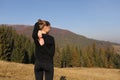 Young sports woman doing yoga exercise on the mountains and sky background in the autumn Royalty Free Stock Photo