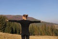 Young sports woman doing yoga exercise on the mountains and sky background in the autumn Royalty Free Stock Photo