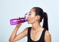 Young sports woman drinks bottled water