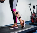 Young sports woman with electrostimulator on the muscles of the legs. Royalty Free Stock Photo