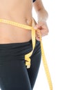 Young sports woman measuring waist. Royalty Free Stock Photo