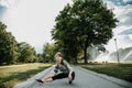 Young sports woman stretching legs on the stairs in the modern city. Healthy lifestyle in the big city. Sports woman relaxing list Royalty Free Stock Photo