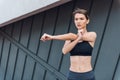 Young sports women running outdoors in front of concrete wall