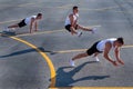 Young sportsman doing gymnastic exercises outdoors.