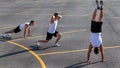 Young sportsman doing gymnastic exercises outdoors