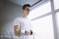 Young sportsman doing workout with dumbbell Royalty Free Stock Photo