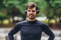 Sportsman listening to music while doing exercising in the park. Fitness, sport, lifestyle concep Royalty Free Stock Photo