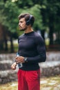 Sportsman listening to music while doing exercising in the park. Fitness, sport, lifestyle concep Royalty Free Stock Photo