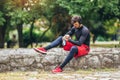 Sportsman listening to music while doing exercising in the park. Fitness, sport, lifestyle concep Royalty Free Stock Photo