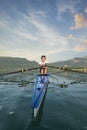 The young sportsman is rowing on the racing kayak