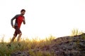 Young Sportsman Running on the Rocky Mountain Trail at Sunset. Active Lifestyle Royalty Free Stock Photo