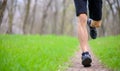 Young Sportsman Running on the Spring Forest Trail in Morning. Legs Close up View Royalty Free Stock Photo