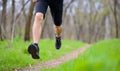 Young Sportsman Running on the Spring Forest Trail in Morning. Legs Close up View Royalty Free Stock Photo