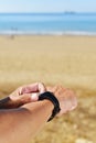 Young sportsman syncing his smartwatch