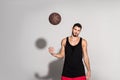 young sportsman throwing basketball ball and looking at camera Royalty Free Stock Photo