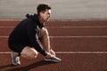 Young sportsman with wireless earphones