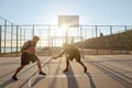 Young sportsmen playing basketball on sports court