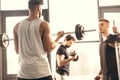 young sportsmen training with barbells