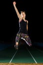 Young sportswoman flying in long jump attempt Royalty Free Stock Photo