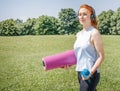 Athletic girl portrait starting or finishing outdoor workout in public park