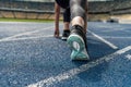 Young sportswoman in starting position on running track stadium Royalty Free Stock Photo