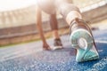 Young sportswoman in starting position on running track stadium Royalty Free Stock Photo