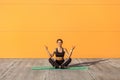 Young sporty attractive woman practicing yoga, doing ardha padmasana exercise, meditating in half lotus pose with mudra gesture Royalty Free Stock Photo