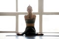 Young sporty attractive woman practicing yoga, doing Gomukasana