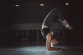 Young sporty attractive woman practicing yoga, doing Vrischikasana, Scorpion exercise, handstand pose, working out, wearing Royalty Free Stock Photo