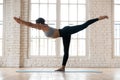 Young sporty attractive woman practicing yoga, doing Warrior thr Royalty Free Stock Photo