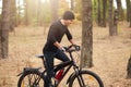 Young sporty biker riding on bike in inspirational forest landscape. Man cycling MTB on enduro trail path, covering assigned Royalty Free Stock Photo