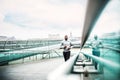 Young sporty black man runner running on the bridge outside in a city. Royalty Free Stock Photo