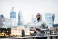 Young sporty black man runner running on the bridge outside in a city. Royalty Free Stock Photo