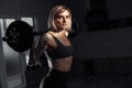 Young sporty blonde woman doing heavy barbell exercise in fitness class. Royalty Free Stock Photo