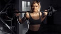 Young sporty blonde woman doing heavy barbell exercise in fitness class. Royalty Free Stock Photo