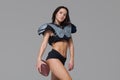 Young sporty brunette wearing sexy uniform of American football player posing with ball looking at camera  on Royalty Free Stock Photo