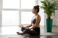 Young woman practicing yoga, doing Easy Seat exercise, Sukhasana Royalty Free Stock Photo