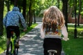 Young sporty couple riding on mountain bicycle on the road. Back view